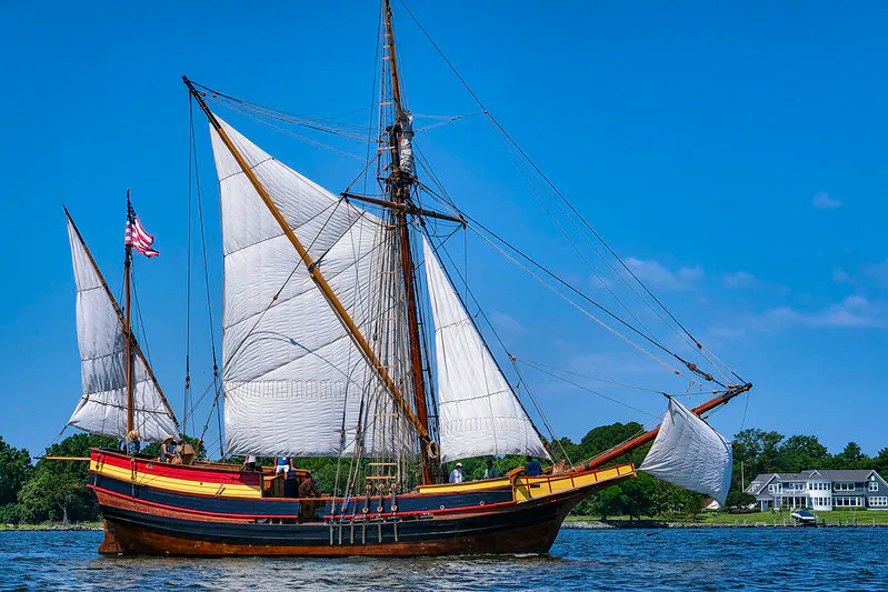 The ship Maryland Dove in the river, with sails unfurled.